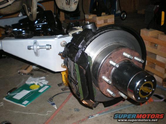 Front axle assembly with disc brake caliper and rotor, black and silver
