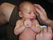 1997 Ford F-250 - A newborn baby is being held by adults, with a yellow band on its arm.