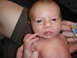 1997 Ford F-250 - A close-up photo of a newborn baby, with adult hands holding them and a pacifier visible.