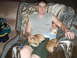 1997 Ford F-250 - A man relaxes on a couch with his baby and two dogs, covered by a patterned blanket.