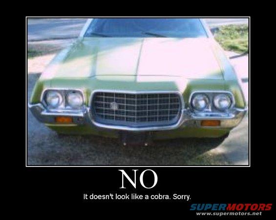 Green car front end with chrome grille and dual headlights