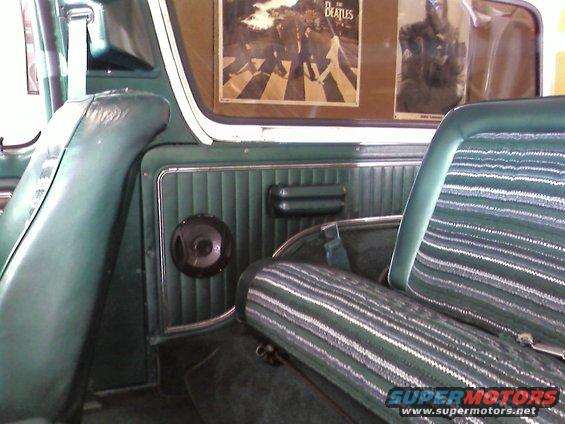 Green interior of a 1978 Ford Bronco with striped seats and Beatles Abbey Road poster