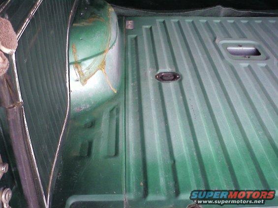 green truck bed with ribbed floor and tie-down points
