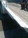 1978 Jeep Cherokee - A trailer ramp with wooden decking and two large axles is visible.