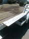 1978 Jeep Cherokee - Trailer frame and deck with various axles in the background.