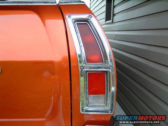 Orange 1979 Ford Ranchero rear tail light assembly with chrome trim