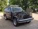 1987 Ford Bronco - This 1987 Ford Bronco shows significant damage to its front end, including the grille and headlights, and is equipped with a roof rack mult…