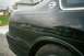 1996 Chevrolet Impala - Rear quarter panel view of a black 1996 Chevrolet Impala, showing the distinctive Impala emblem.