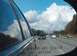 1996 Chevrolet Impala - Reflection in a car's side mirror shows multiple vehicles on a highway, with the common warning text visible.