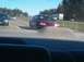 1996 Chevrolet Impala - A red sedan is seen on the road, with a large pile of gravel in the foreground.