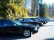 1996 Chevrolet Impala - A row of black sedans, including a 1996 Chevrolet Impala, are parked outdoors.