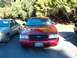 1996 Chevrolet Impala - Front view of a red Ford Crown Victoria, parked next to another car.