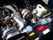 1996 Chevrolet Impala - Close-up of a modified engine bay a Flowmaster sticker and aftermarket air intake components.