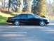1996 Chevrolet Impala - A black 1996 Chevrolet Impala sedan is parked on the side of the road with another vehicle behind it.