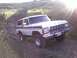 1978 Ford Bronco - This 1978 Ford Bronco is captured driving on a dirt path with the sun glinting off its chrome.