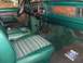 1978 Ford Bronco - The interior of a 1978 Ford Bronco shows green upholstery and woodgrain accents.