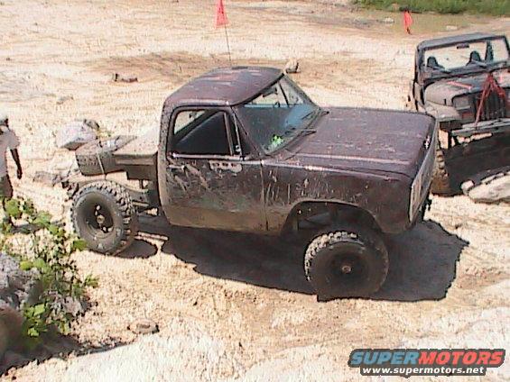 Brown pickup truck with lifted suspension and off-road tires, 1972 model year