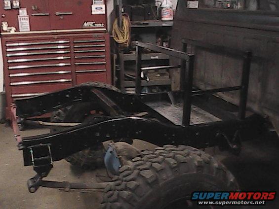 Truck chassis with large tires and custom rack, side view