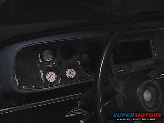 Interior shot of a vehicle's dashboard with multiple gauges visible