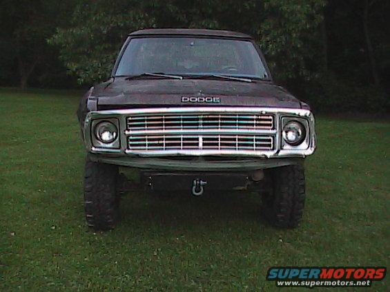 Front view of a dark colored Dodge Ramcharger with a chrome grille and tow hook