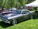 1972 Ford Ranchero - Custom 1965 Chevrolet Impala on display at an outdoor car show with other vehicles present.