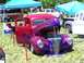 1972 Ford Ranchero - A custom pickup truck with a unique paint job is displayed at a car show with tents in the background.