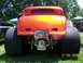 1972 Ford Ranchero - This orange hot rod coupe is parked outdoors, showing off its wide rear tires and custom bumper.