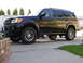 2002 Toyota Sequoia - Side view of a black 2002 Toyota Sequoia SUV with aftermarket wheels.