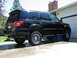 2002 Toyota Sequoia - Black SUV parked in driveway.