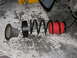 2002 Toyota Sequoia - Suspension components laid out on a garage floor, including a coil spring and bump stop.