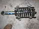 2002 Toyota Sequoia - A vehicle's shock absorber assembly is shown with a spring compressor tool engaged on the coil spring.