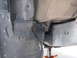 2002 Toyota Sequoia - Undercarriage view of a vehicle, focusing on the fender liner and frame structure with a jack in place.