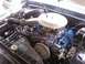 1978 Ford Bronco - Detailed view of the engine compartment in a 1978 Ford Bronco, highlighting the carburetor and blue valve covers.