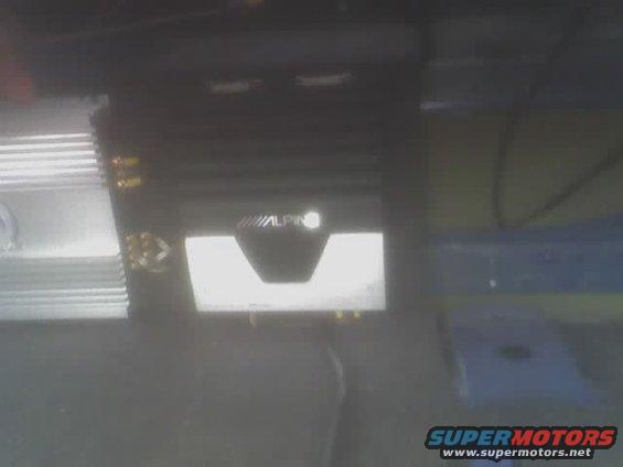 Alpine car audio amplifier with heatsink fins and illuminated logo