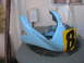 2005 Yamaha R1 - A light blue motorcycle fairing with a yellow and black number plate '81' is shown resting on an outdoor air conditioning unit.