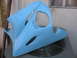 2005 Yamaha R1 - A light blue motorcycle fairing part is shown resting on an outdoor air conditioning unit.