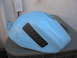 2005 Yamaha R1 - A light blue motorcycle fuel tank rests on an outdoor air conditioning unit.