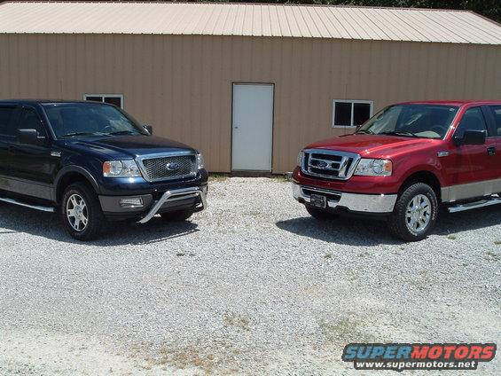 Two Ford F-150 trucks, one blue and one red, parked outside