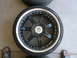 1996 Ford Probe - A black aftermarket wheel with a silver lip and five split spokes is shown, with two tires stacked behind it.