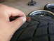 1996 Ford Probe - A penny is used to measure the tread depth of a tire, indicating wear.