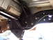 1996 Ford Bronco - Close-up view of aftermarket rear suspension components installed on a vehicle frame.