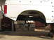 1996 Ford Bronco - The rear suspension of a white 1996 Ford Bronco is shown, with a fuel tank suspended beneath the frame.