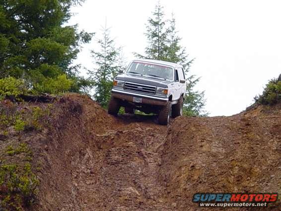 White and black SUV on a steep dirt incline