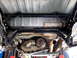 1996 Ford Bronco - Close-up of the rear suspension and drivetrain components from underneath.