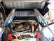 1996 Ford Bronco - Underneath view of a vehicle's rear suspension, showing dual Fox shocks and the transfer case.