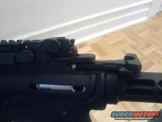 Black firearm receiver with rail system and rear sight