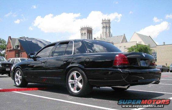 2003 Mercury Marauder parked with hood open, other vehicles and buildings in background