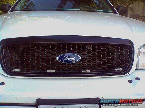 White 2000 Ford Crown Victoria front grille with Ford logo and honeycomb pattern