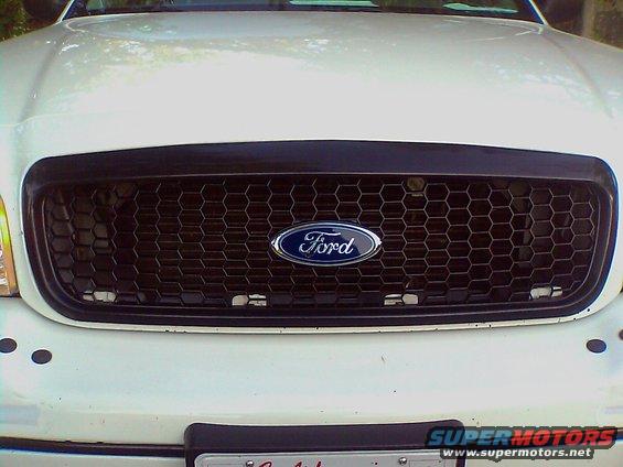 White Ford Crown Victoria grille with honeycomb pattern and Ford logo
