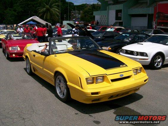 Yellow convertible Mustang GT with black stripe on hood